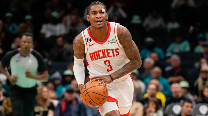 Kevin Porter Jr. holds the ball in both hands preparing to throw it